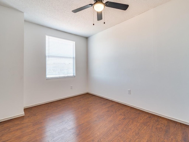 unfurnished room featuring a textured ceiling, dark hardwood / wood-style floors, and ceiling fan