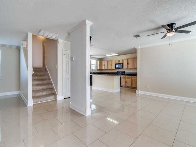 unfurnished living room with ceiling fan, sink, and ornamental molding