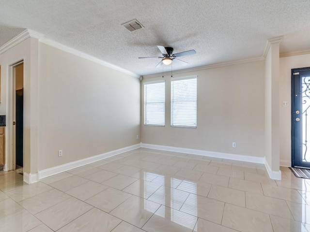 tiled empty room with a textured ceiling, ceiling fan, and crown molding