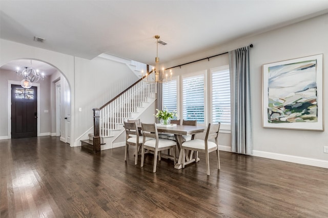 dining area featuring an inviting chandelier and dark hardwood / wood-style flooring