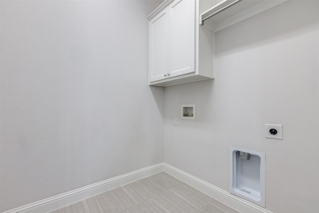 washroom with cabinets, hookup for a washing machine, and electric dryer hookup