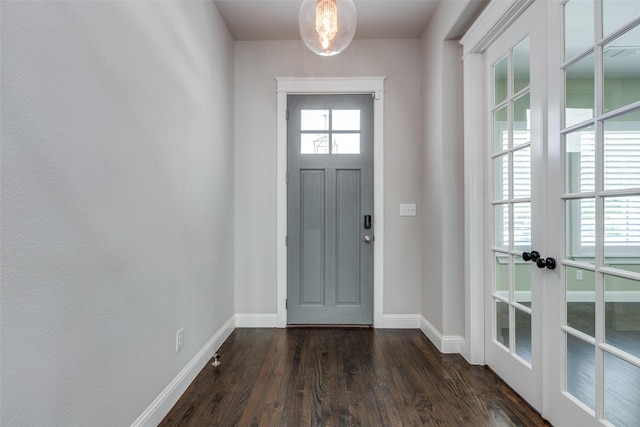 entryway with dark hardwood / wood-style floors and french doors