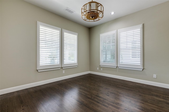 unfurnished room with dark hardwood / wood-style floors