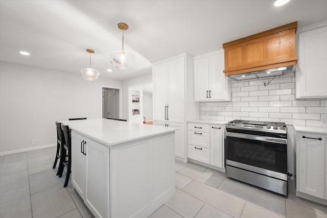 kitchen with white cabinetry, a kitchen island, pendant lighting, and stainless steel range oven