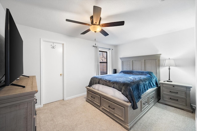 bedroom featuring ceiling fan and light colored carpet