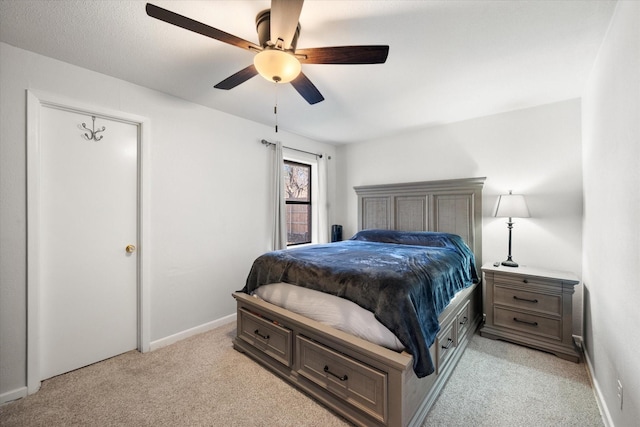 bedroom with ceiling fan and light colored carpet