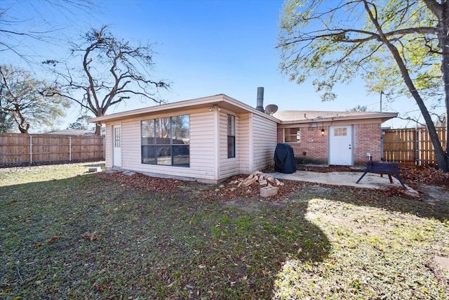 rear view of house featuring a lawn