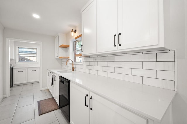 kitchen with light tile patterned floors, a wealth of natural light, sink, and white cabinets