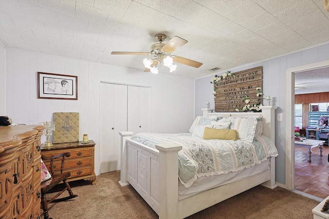 bedroom with a closet, ceiling fan, and carpet