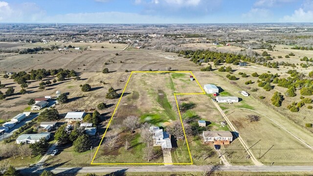 birds eye view of property featuring a rural view