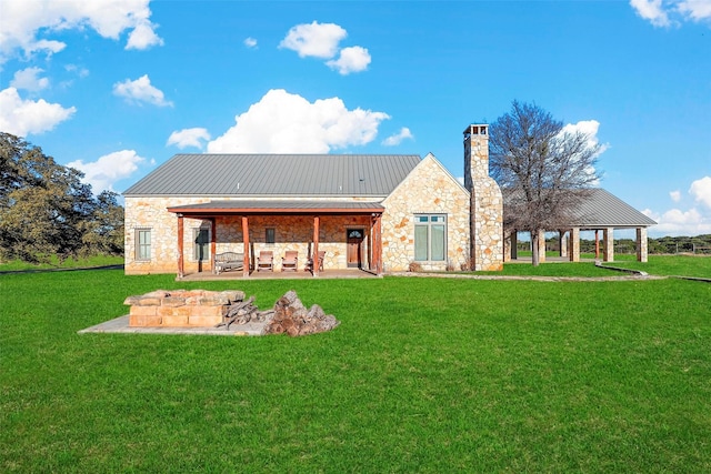 back of house featuring a patio and a lawn