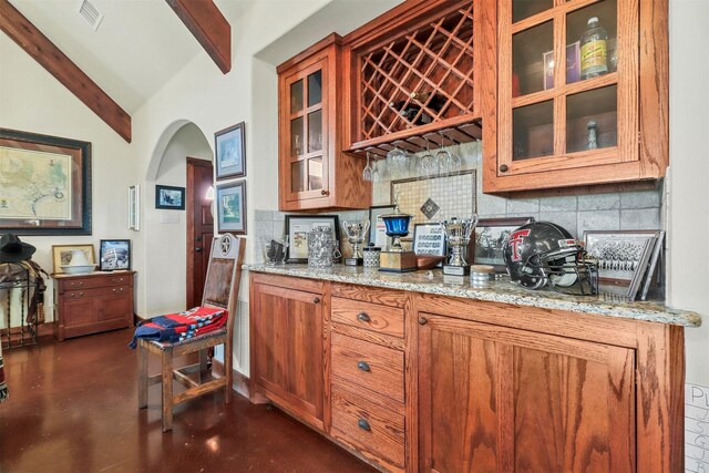 dining space featuring beamed ceiling and high vaulted ceiling