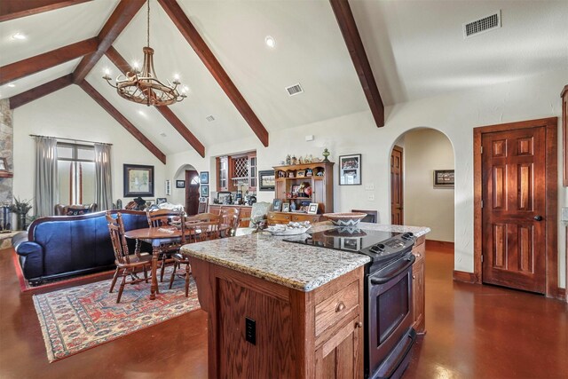 kitchen with a center island, high vaulted ceiling, sink, appliances with stainless steel finishes, and light stone counters