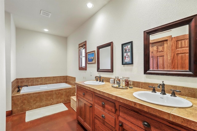 bathroom with vanity and a relaxing tiled tub