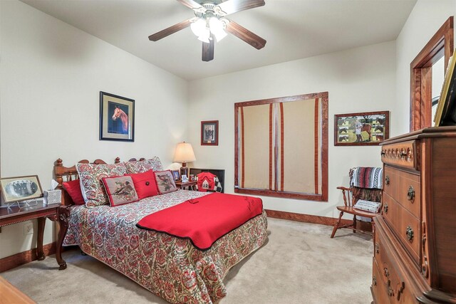 bedroom featuring light colored carpet and ceiling fan