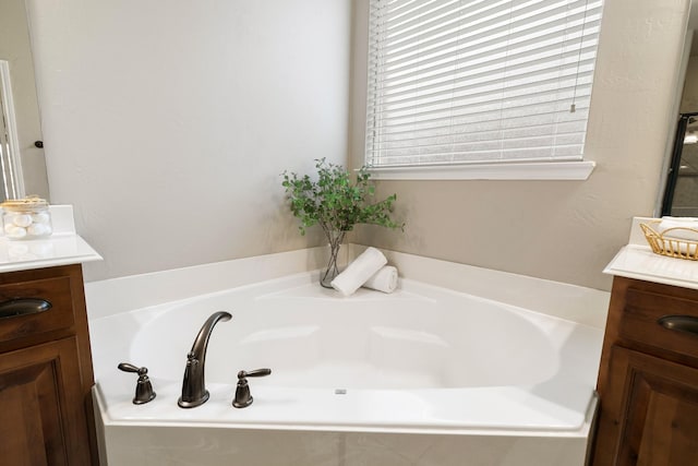 full bathroom featuring vanity and a garden tub