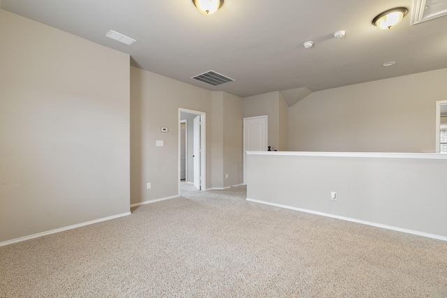 empty room with visible vents, baseboards, and light colored carpet