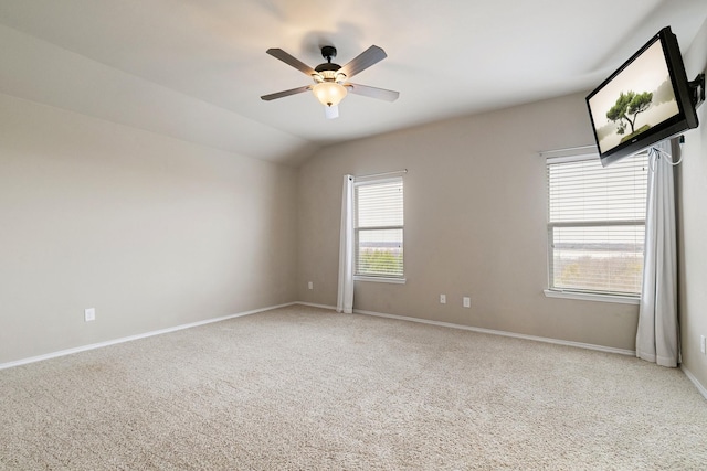 unfurnished room featuring baseboards, carpet floors, ceiling fan, and vaulted ceiling