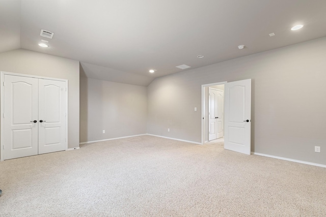 empty room with vaulted ceiling, recessed lighting, baseboards, and visible vents