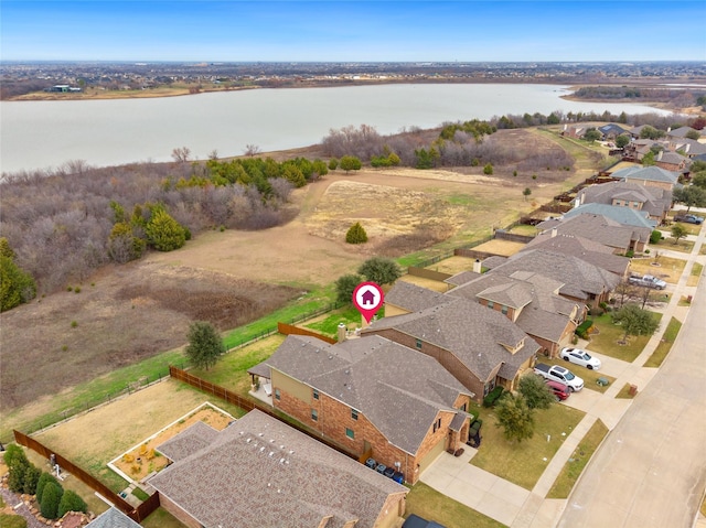 birds eye view of property with a water view and a residential view