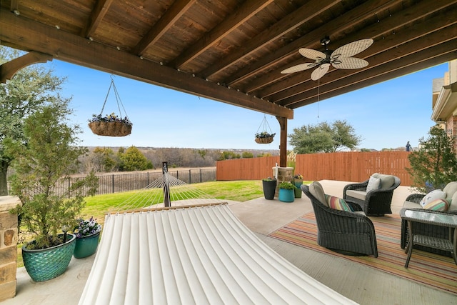 wooden deck with a lawn, a patio, a fenced backyard, outdoor lounge area, and ceiling fan