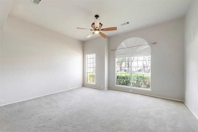 carpeted empty room featuring ceiling fan