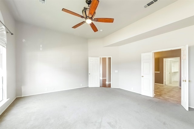 unfurnished room with ceiling fan and carpet