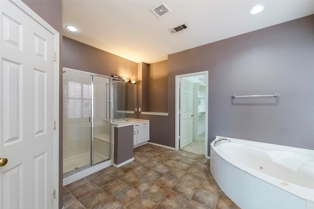 bathroom featuring vanity and shower with separate bathtub