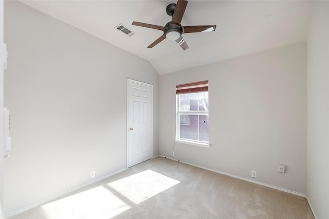 carpeted empty room with ceiling fan and lofted ceiling