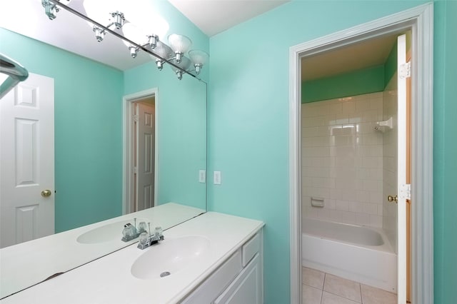 bathroom with tile patterned flooring, vanity, and tiled shower / bath