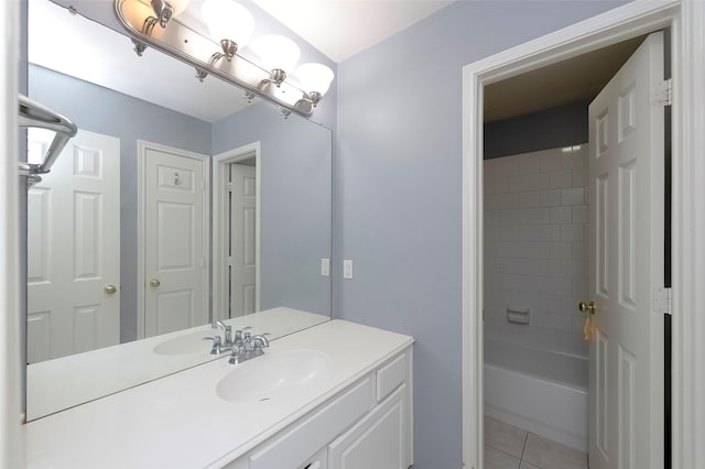 bathroom featuring tile patterned floors, vanity, and tiled shower / bath