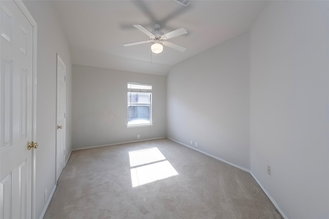 empty room with ceiling fan, light carpet, and vaulted ceiling