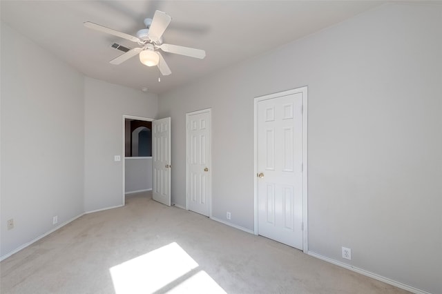 unfurnished bedroom with ceiling fan and light carpet