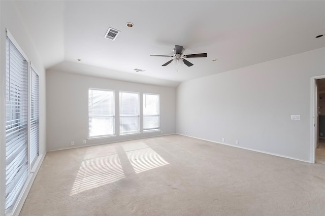 carpeted empty room featuring ceiling fan and lofted ceiling