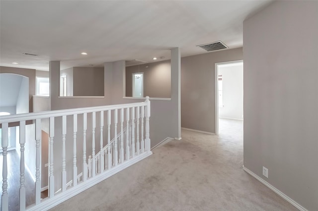 corridor with light colored carpet