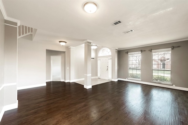 interior space featuring ornamental molding, dark hardwood / wood-style flooring, and ornate columns