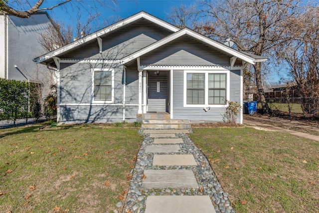 bungalow-style house featuring a front yard