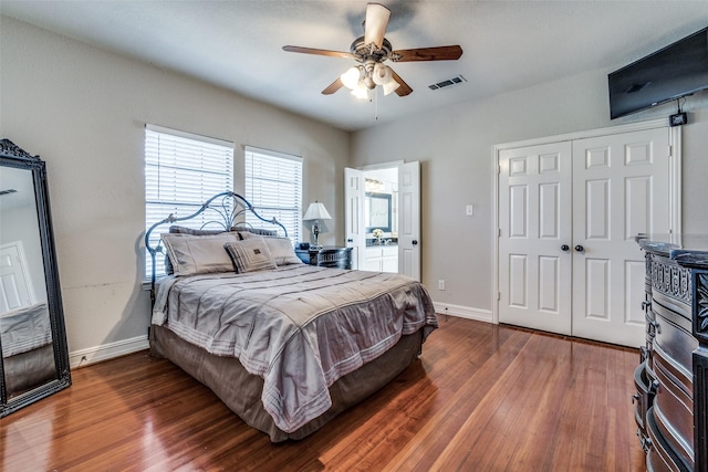 bedroom with a closet, ceiling fan, and dark hardwood / wood-style floors