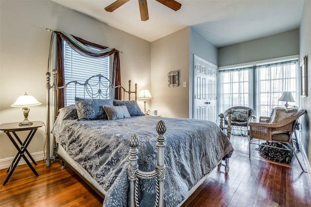 bedroom featuring dark hardwood / wood-style flooring, a closet, and ceiling fan