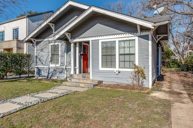 bungalow-style home with a front lawn