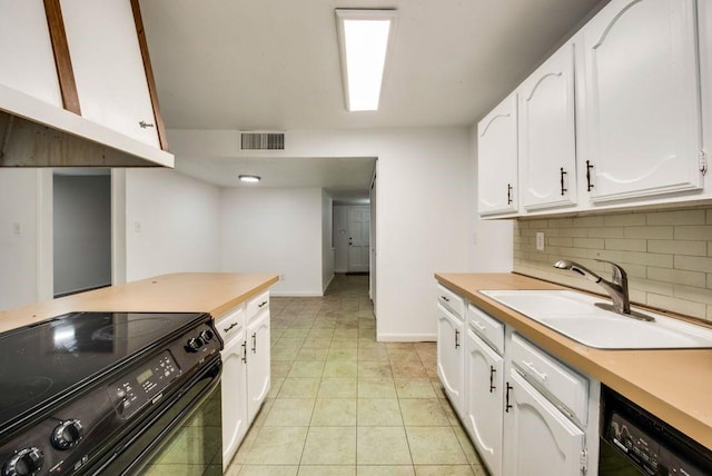 kitchen featuring sink, tasteful backsplash, black appliances, white cabinets, and light tile patterned flooring