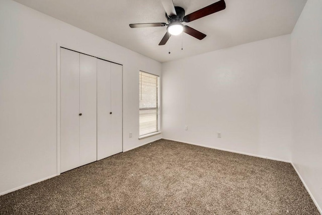 unfurnished bedroom featuring ceiling fan, carpet flooring, and a closet