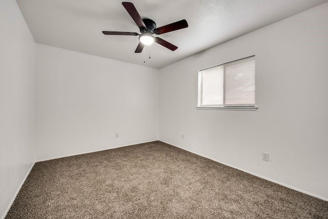 spare room featuring carpet and ceiling fan