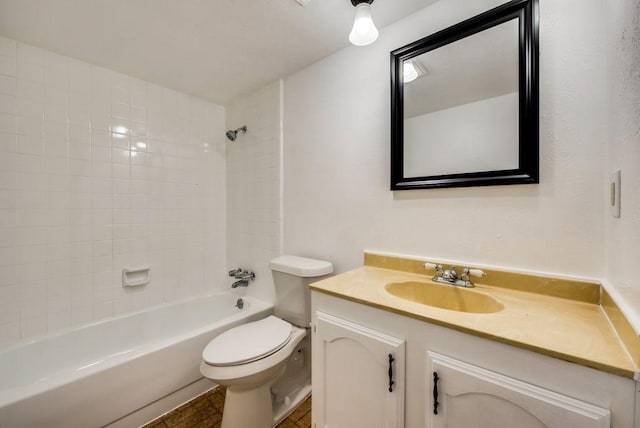 full bathroom with vanity, tiled shower / bath combo, and toilet