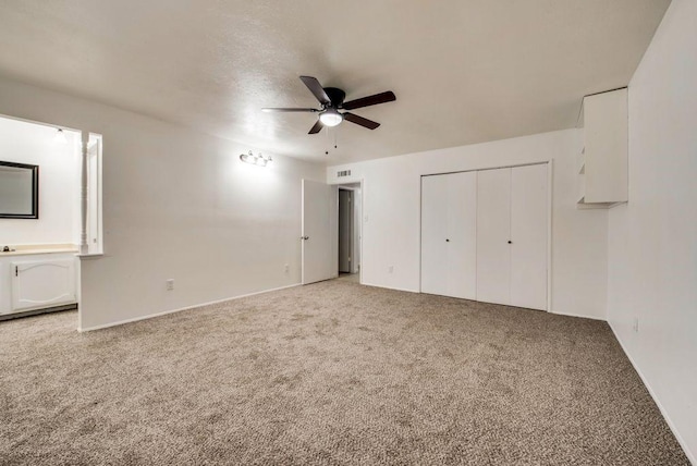 unfurnished bedroom featuring a closet, ceiling fan, and carpet flooring