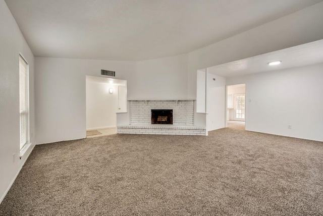 unfurnished living room featuring carpet floors and a fireplace