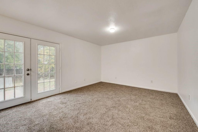 spare room with french doors and carpet flooring