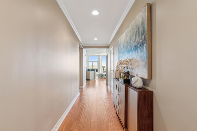 hall with crown molding and light wood-type flooring