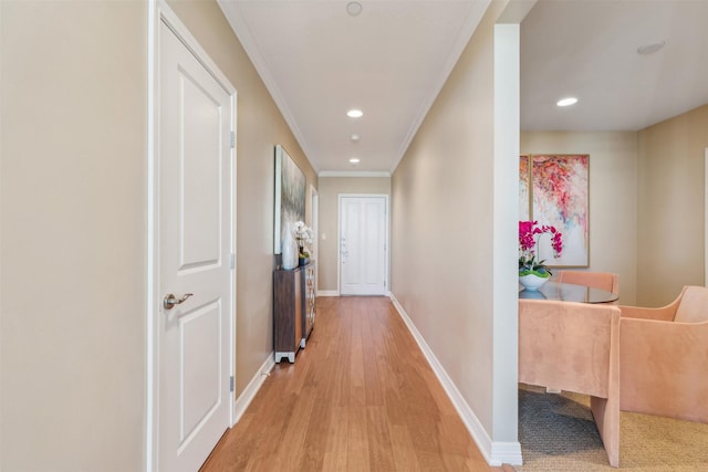 hall featuring light wood-type flooring and crown molding