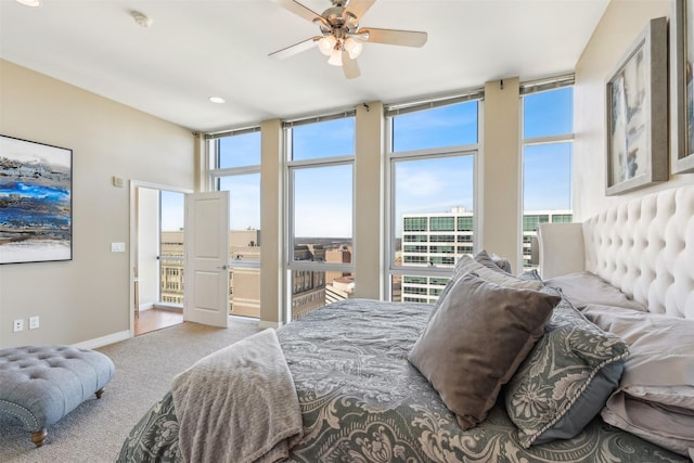 bedroom featuring multiple windows, ceiling fan, carpet, and ensuite bathroom